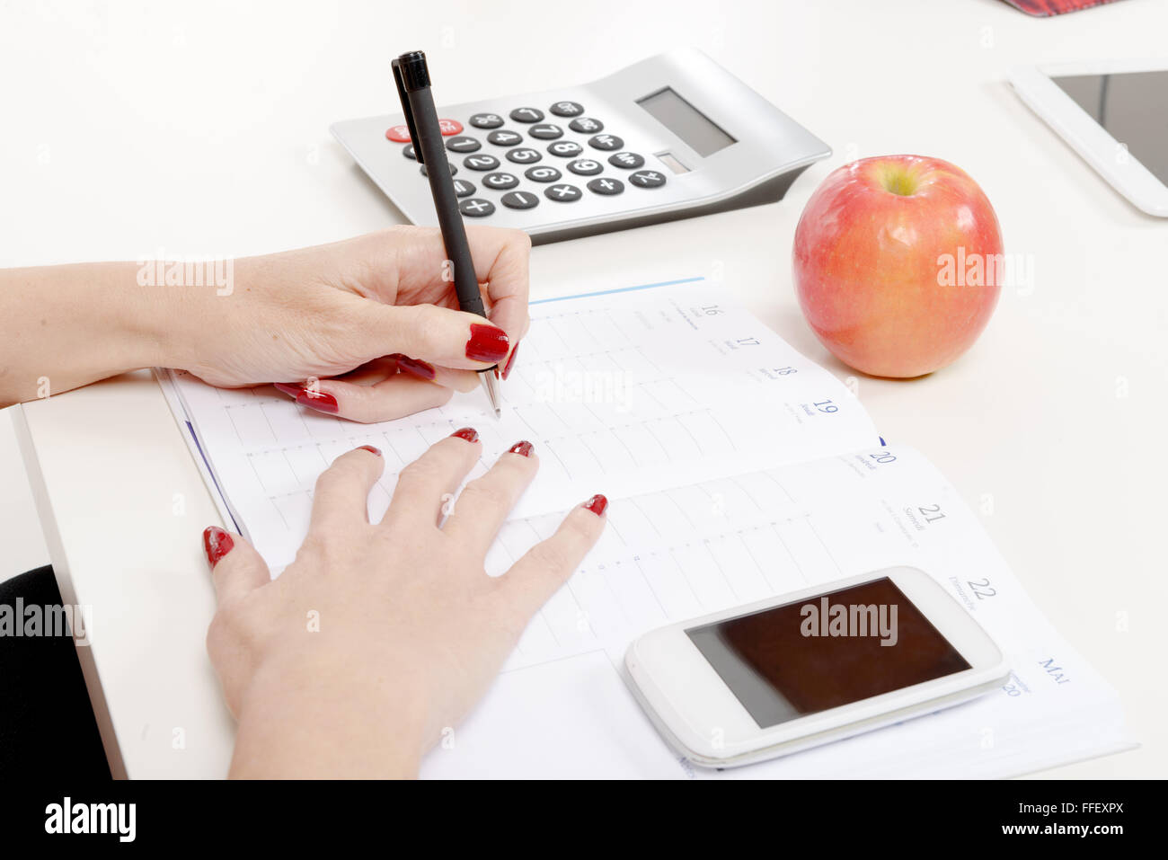 a closeup of woman's hand writing on paper Stock Photo - Alamy