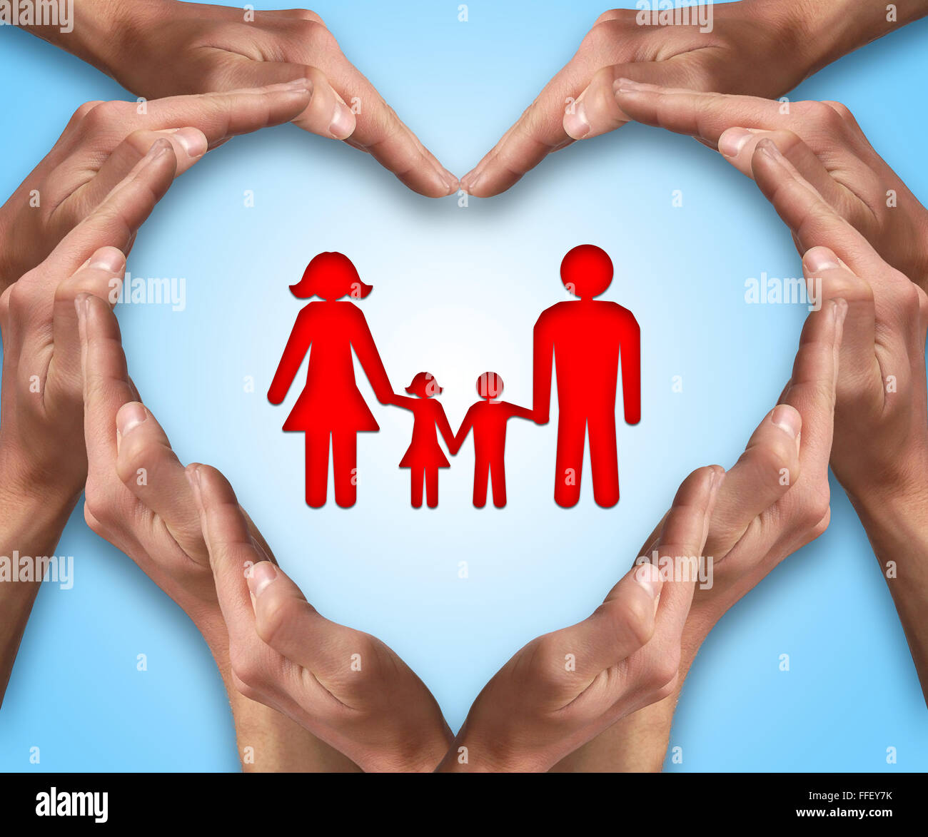 Hands make heart shape with a family in center. Love and protection concept. Family insurance Stock Photo