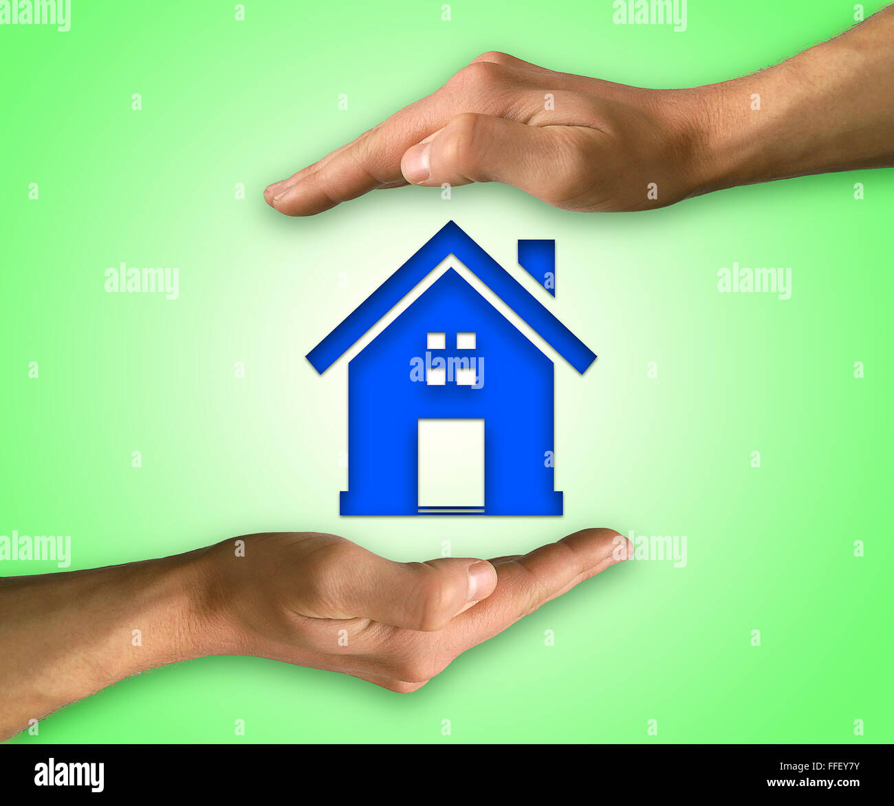 Two hands on top and below to protect a house. Concept of home insurance and protection Stock Photo