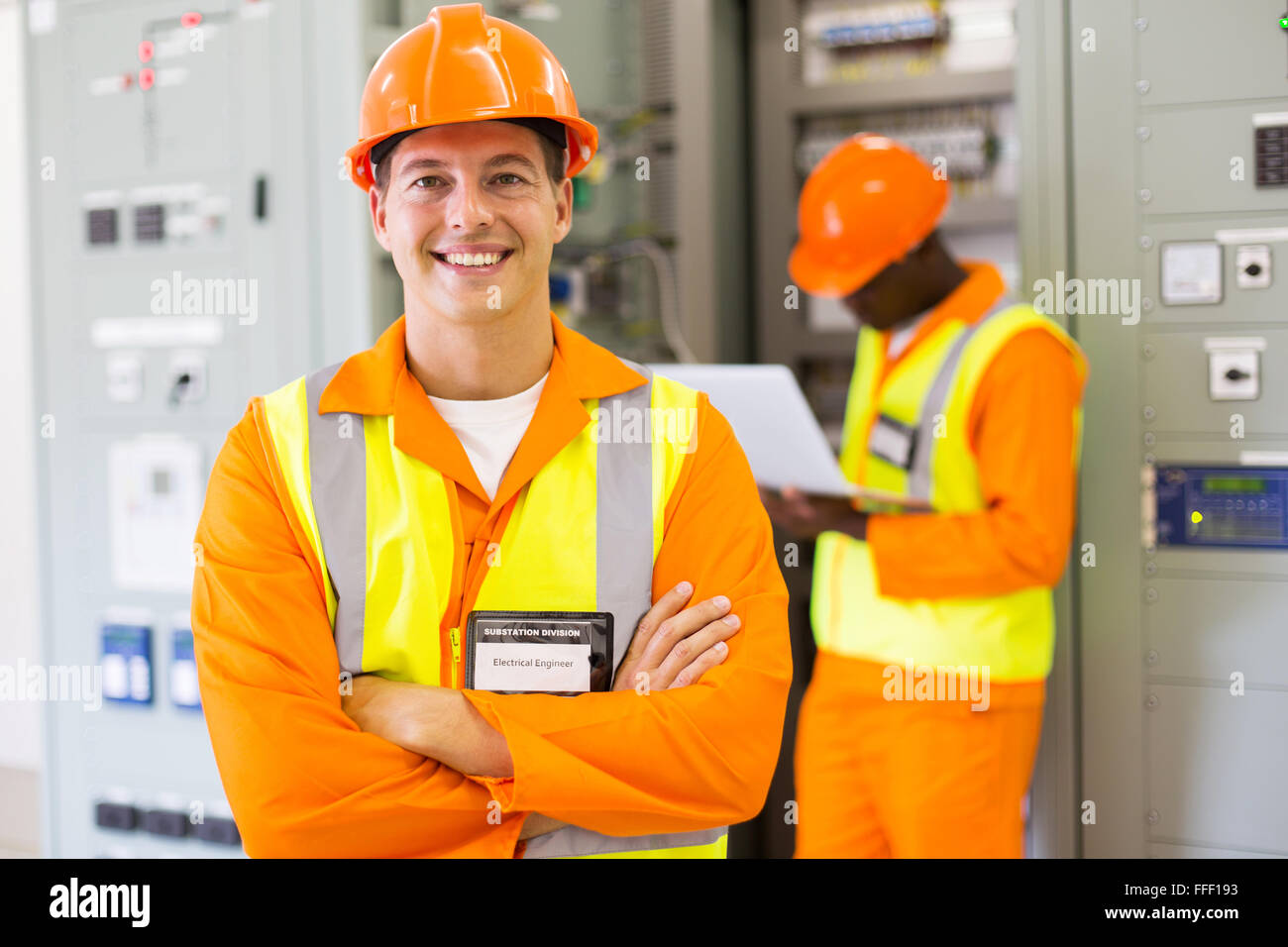 happy industrial engineer with colleague on background in control room