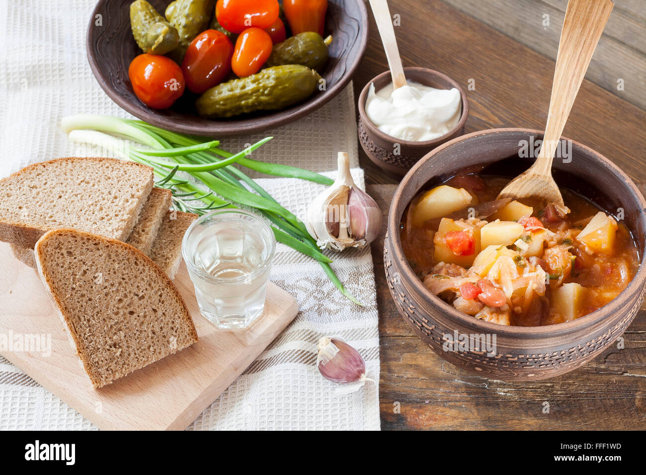 Traditional ukrainian vegetable soup borscht, marinated tomatoes and