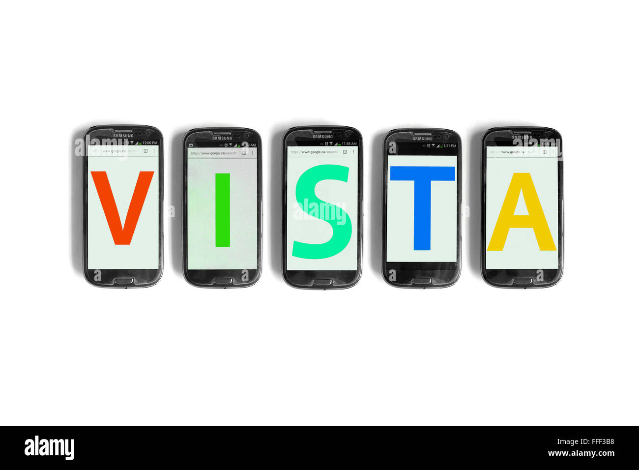Vista written on the screen of smartphones photographed against a white background. Stock Photo