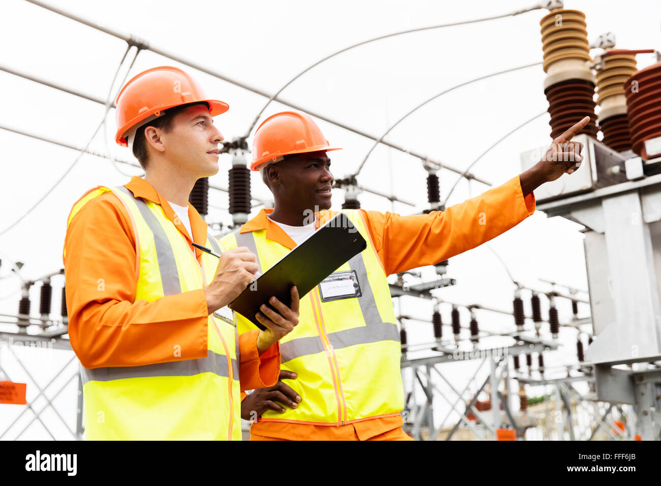 senior technician and electrician working together in power plant Stock Photo