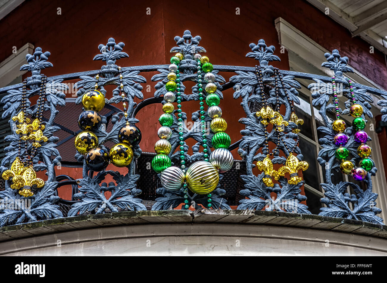 Balcony with Mardi Gras Beads on railing banister  in the French Quarter. Stock Photo