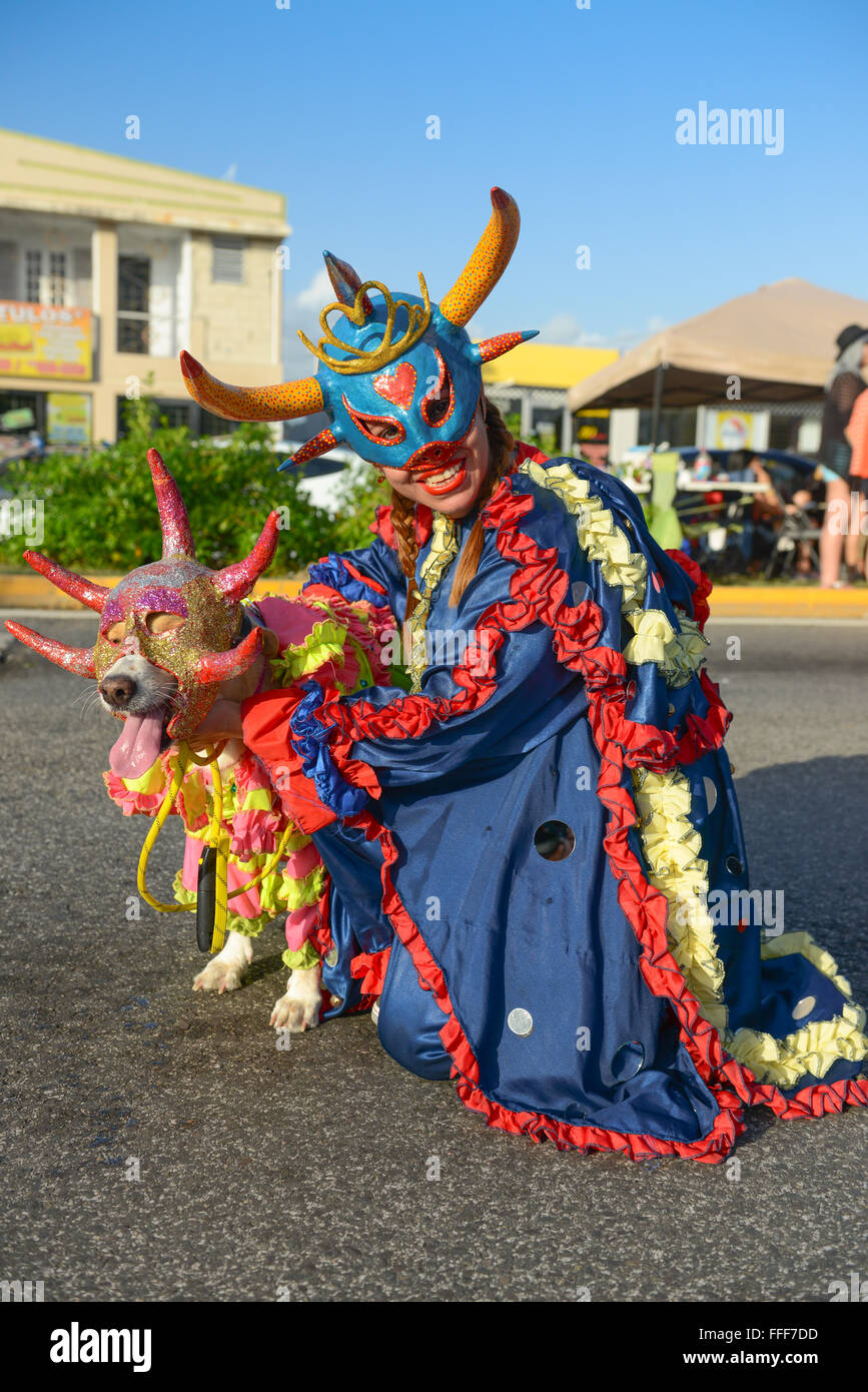 Tradtional VEJIGANTE and her pet dog during the carnival parade in Ponce. Puerto Rico. US territory. February 2016 Stock Photo
