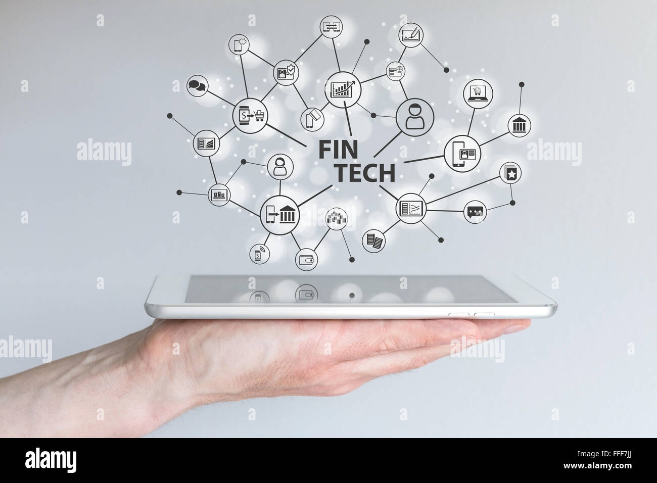 Fin Tech and mobile computing concept. Hand holding tablet Stock Photo