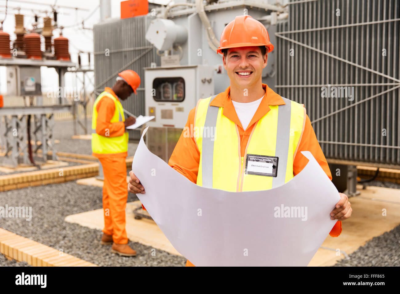 happy industrial engineer working in electric substation Stock Photo