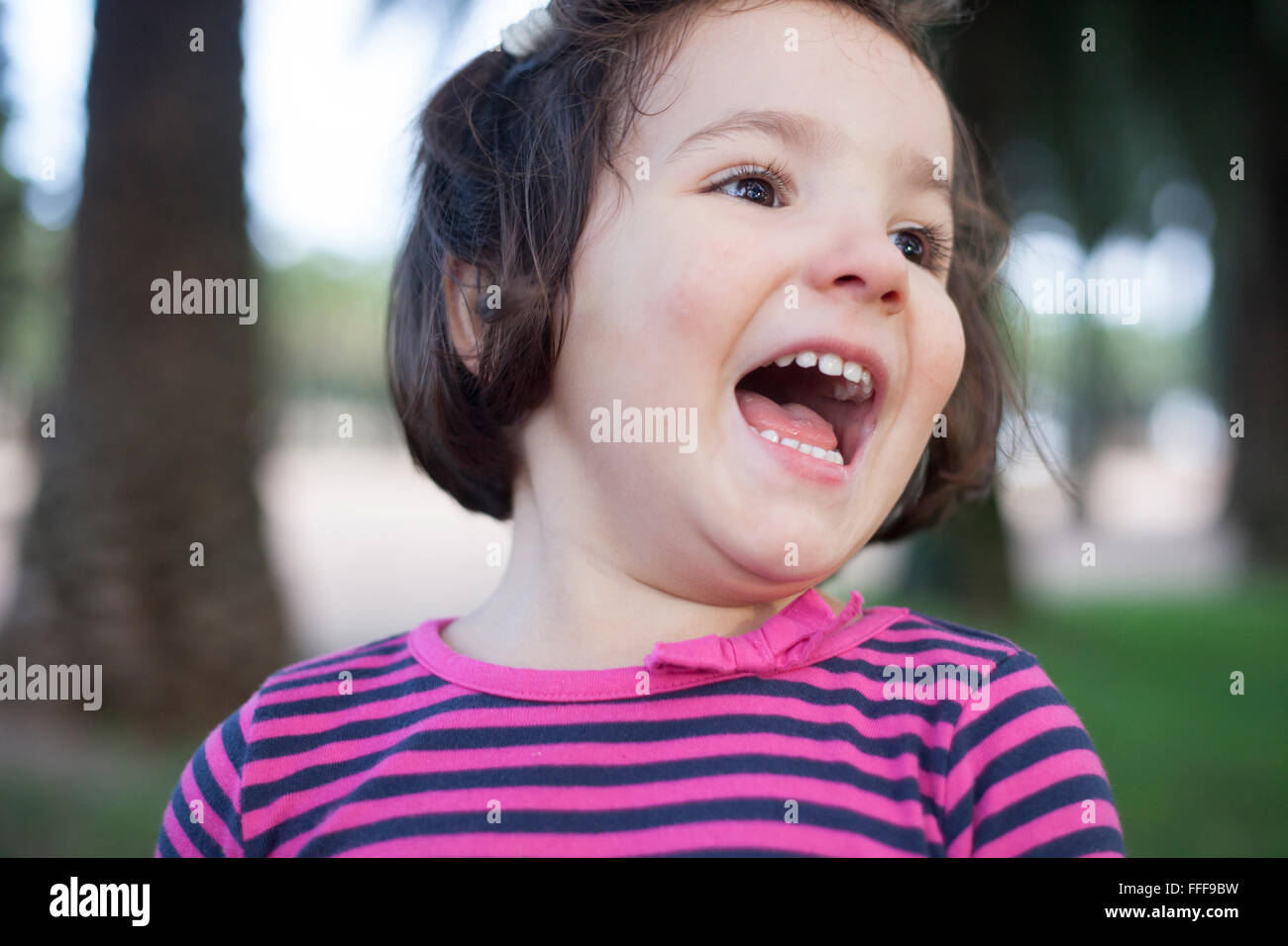 Euphoric three years old little girl. Outdoors portrait Stock Photo