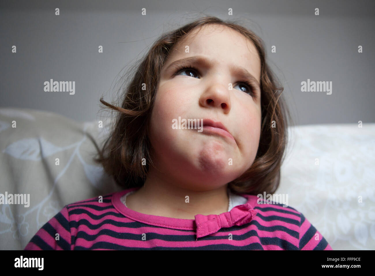 Three years old little girl portrait with crazy expression. Indoors portrait Stock Photo