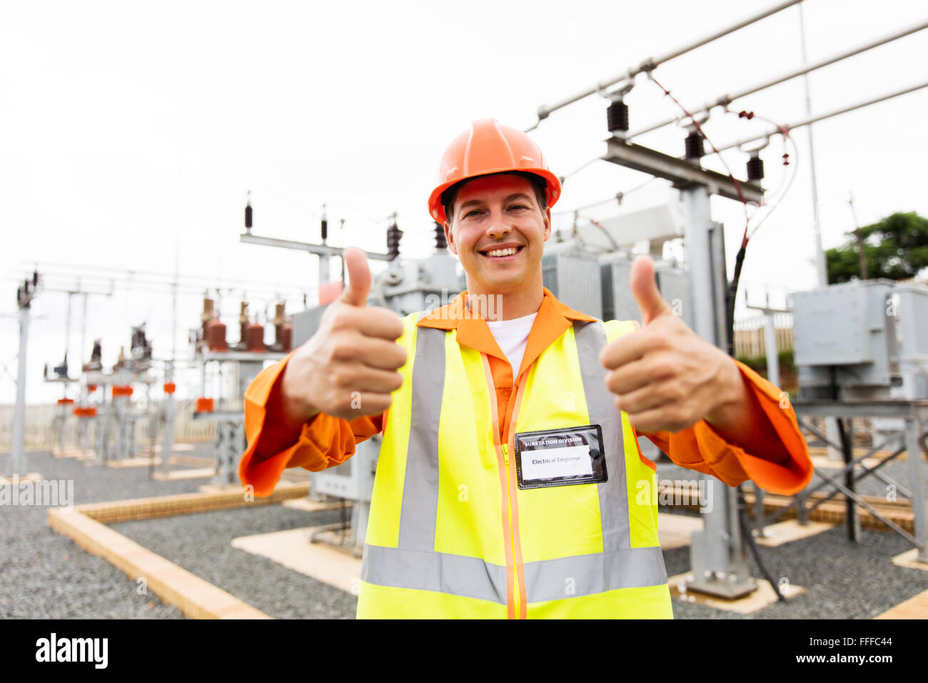 handsome electrician with thumbs up at substation Stock Photo
