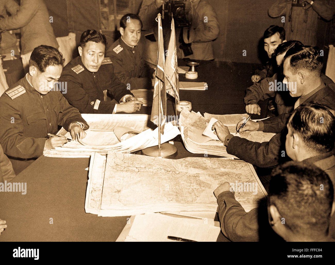 Col. James Murray, Jr., USMC, and Col. Chang Chun San, of the North Korean Communist Army, initial maps showing the north and south boundaries of the demarcation zone, during the Panmunjom cease fire talks.  October 11, 1951. Photo by F. Kazukaitis. (Navy) Stock Photo