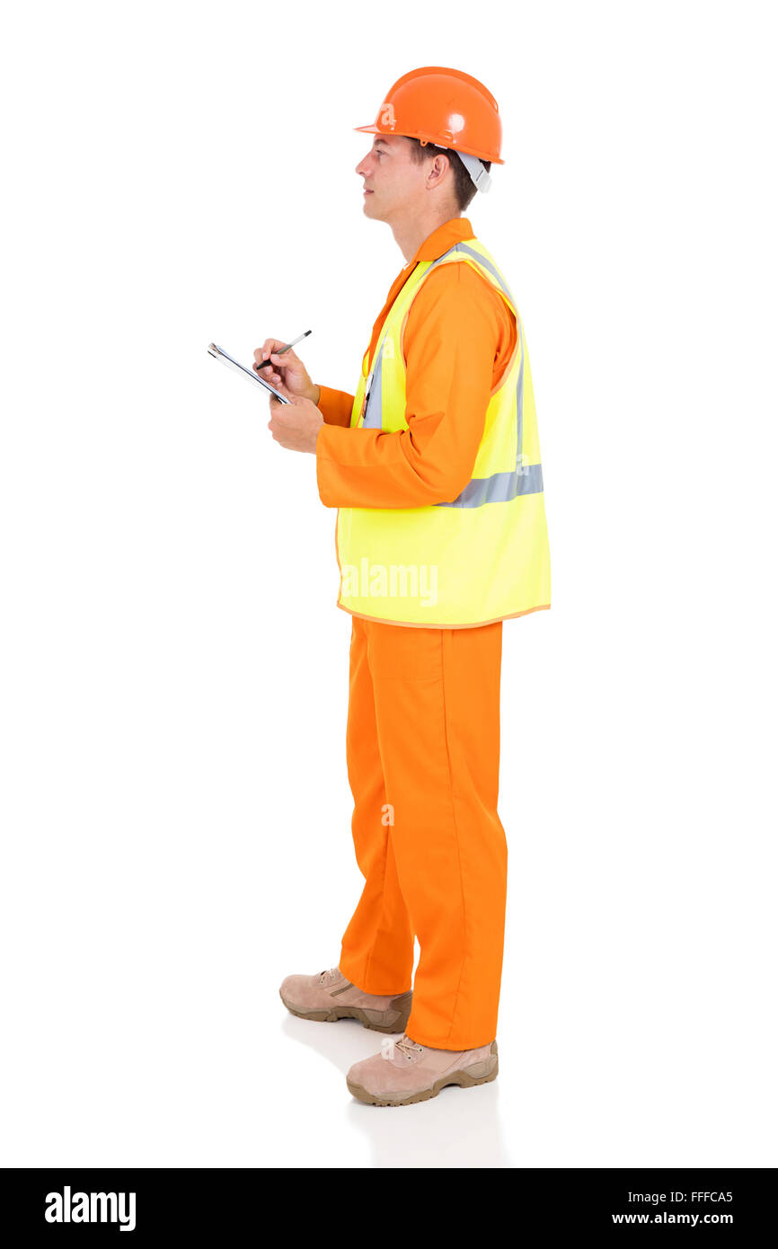 side view of young male electrician writing on clipboard Stock Photo