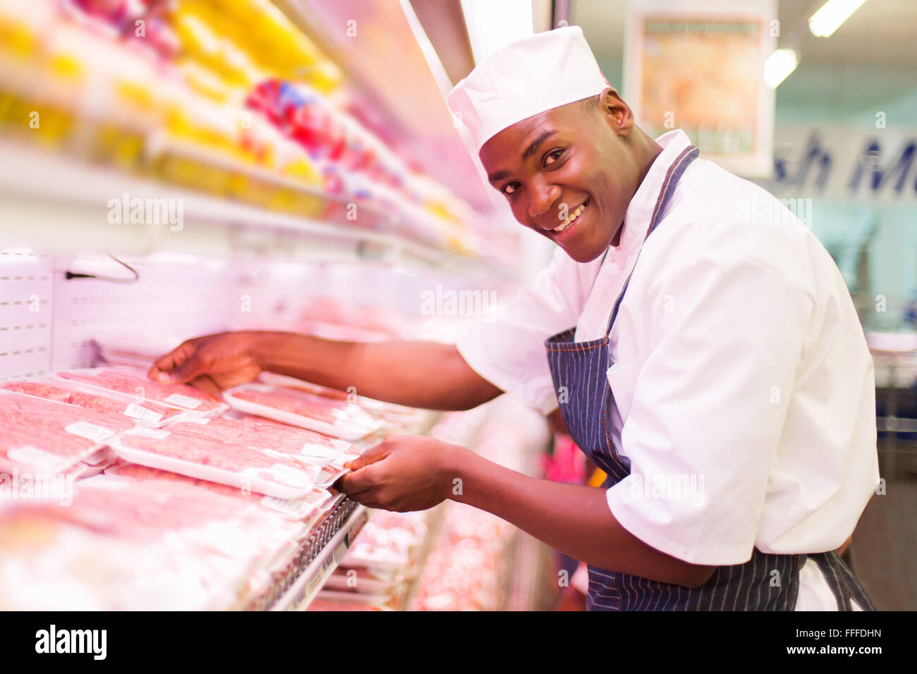 happy African butcher working in butchery Stock Photo