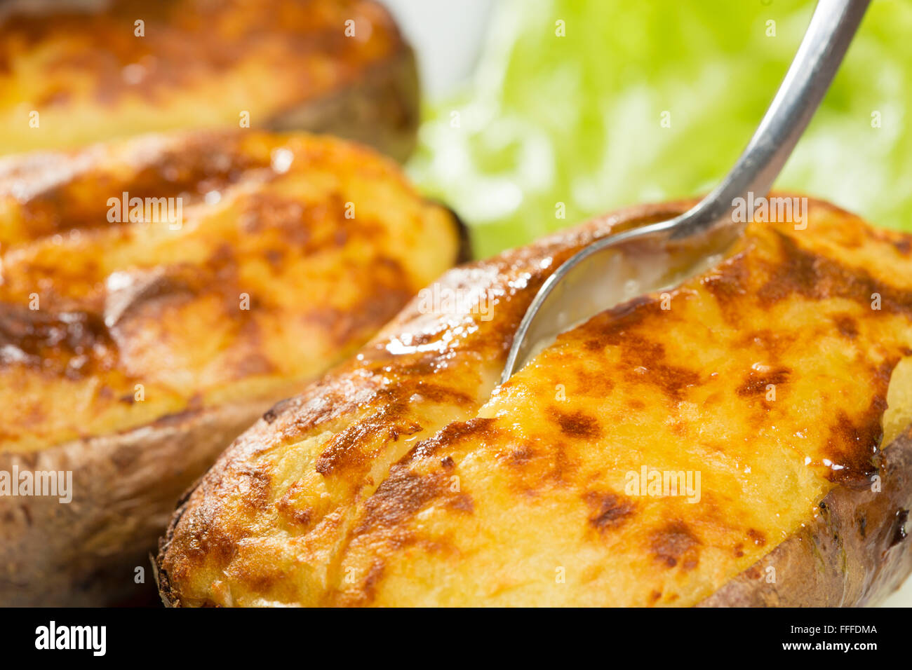 baked potatoes whole in their skins Stock Photo