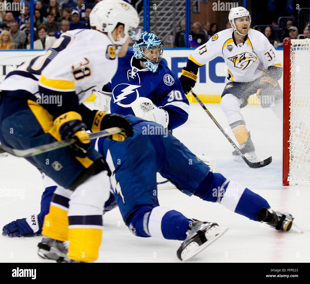 Tampa, Florida, USA. 12th Feb, 2016. DIRK SHADD | Times .Tampa Bay Lightning goalie Ben Bishop (30) works to keep the puck out as legs go flying with Nashville Predators right wing Viktor Arvidsson (38) and Predators center Colin Wilson (33) closing in during second period action at the Amalie Arena in Tampa Friday evening (02/12/16) © Dirk Shadd/Tampa Bay Times/ZUMA Wire/Alamy Live News Stock Photo