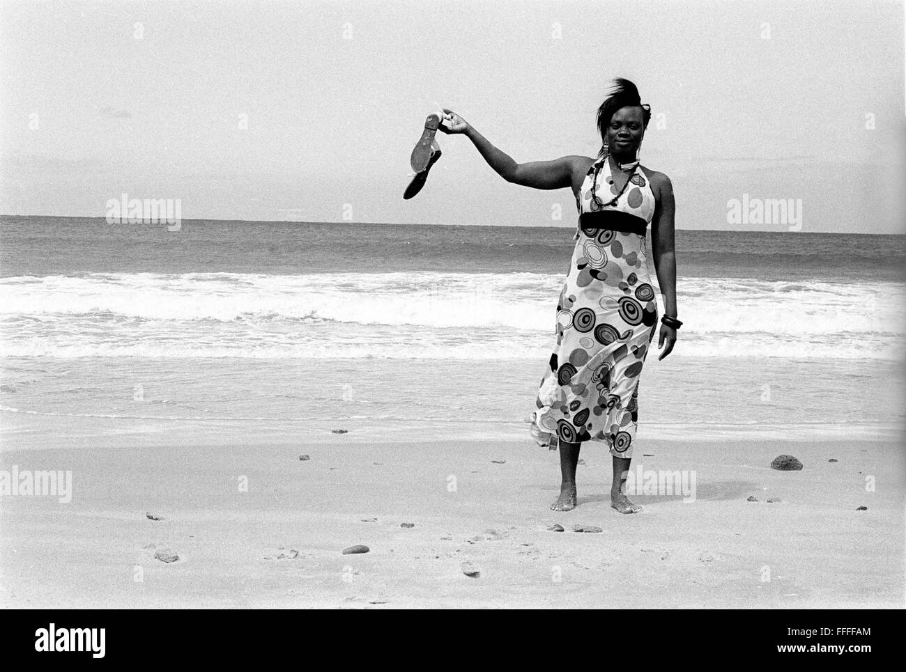 Jan 4, 2016 - South Beach, KwaZulu-Natal, South Africa - A woman on vacation from Maputo in Mozambique. South Beach is a part of the City of Durban's longest uninterrupted stretch of beach sand. The City of Durban is on the eastern seaboard of South Africa and the people here are washed with the warm waters of the Indian Ocean. To the north of this stretch of sand are beaches with cafe society hang outs. To the south there is a pier with the upmarket Moyo's Restaurant at it's end and the uShaka Marine World complex and the private surf and sea clubs of the Vetches Beach area. Between these nor Stock Photo