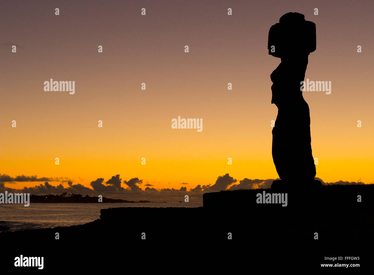 Sunset behind the single moai at Ahu Ko Te Riku, Tahai on Easter Island. Stock Photo