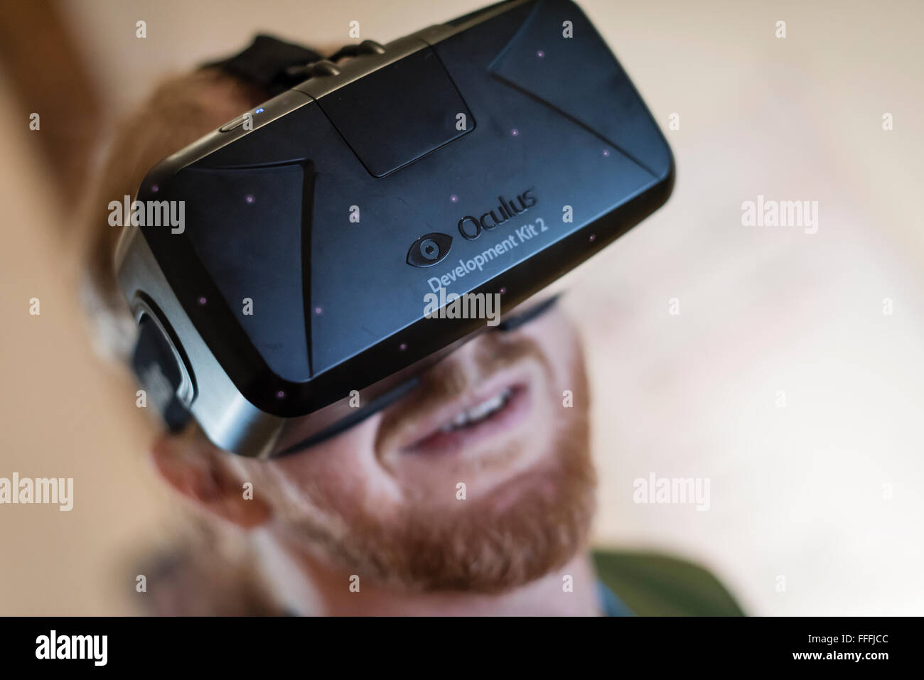A man (Caucasian ethnicity) is wearing Oculus Rift Development Kit 2 (DK2)  virtual reality goggles while playing a computer game Stock Photo - Alamy
