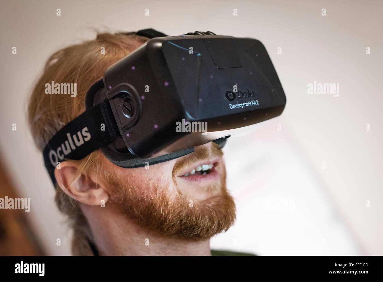 A man (Caucasian ethnicity) is wearing Oculus Rift Development Kit 2 (DK2) reality goggles while playing a computer game Stock Photo - Alamy