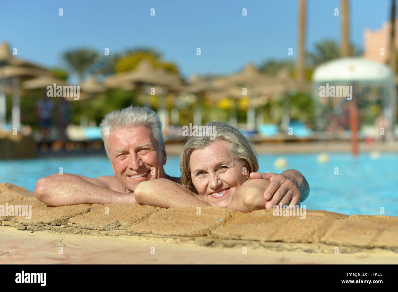 Senior couple relaxing at pool Stock Photo - Alamy