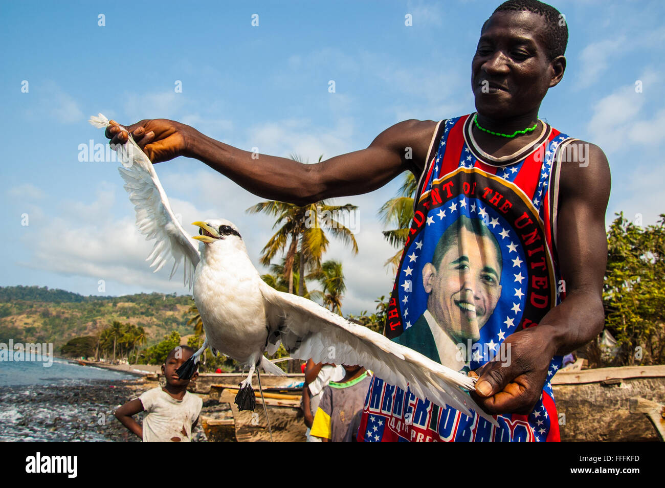 A local fishermen showing a wild sea bird he caught while fishing for sardines. Stock Photo