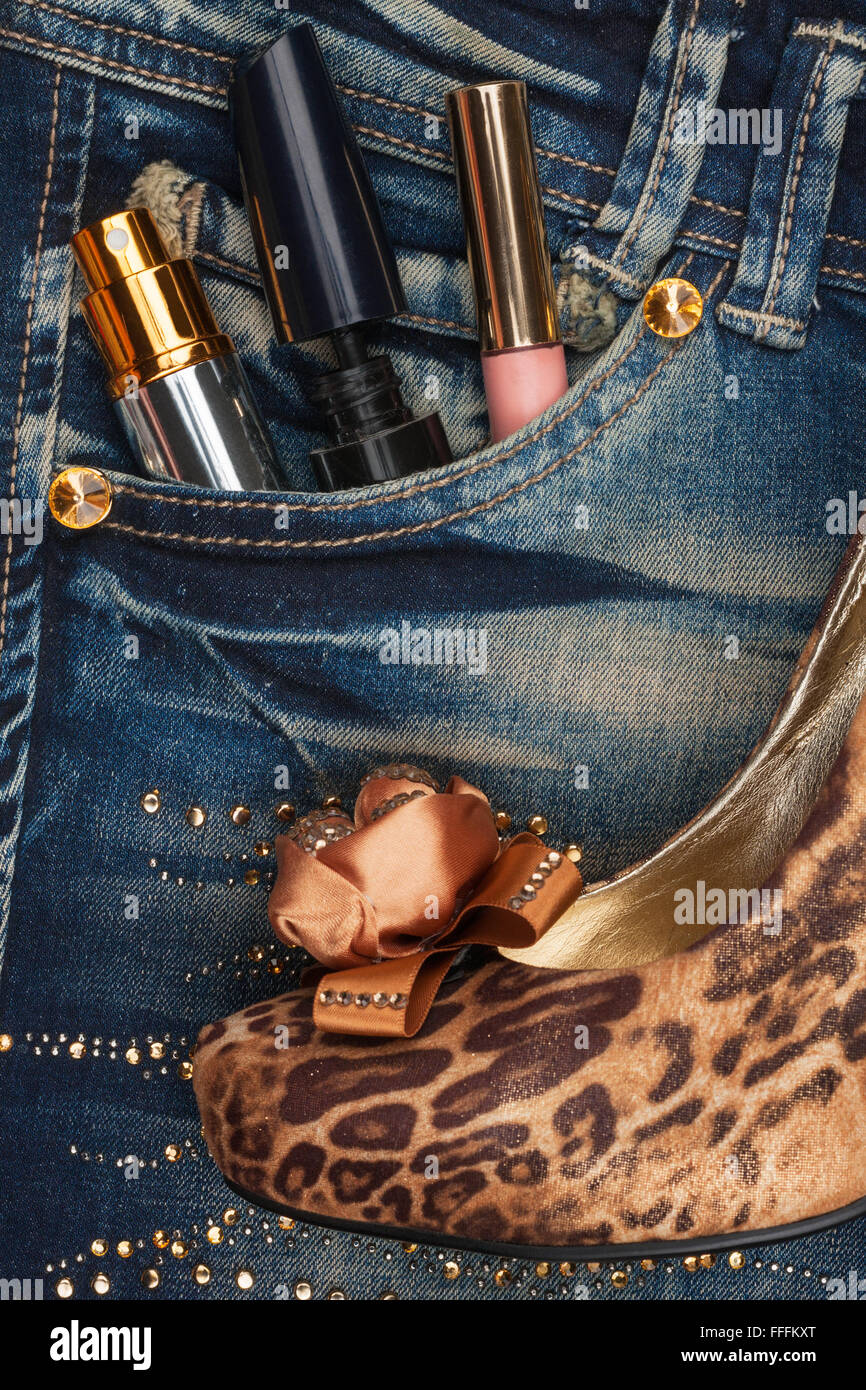 Cosmetics and perfumery sticks out of the pocket of his jeans, as background Stock Photo
