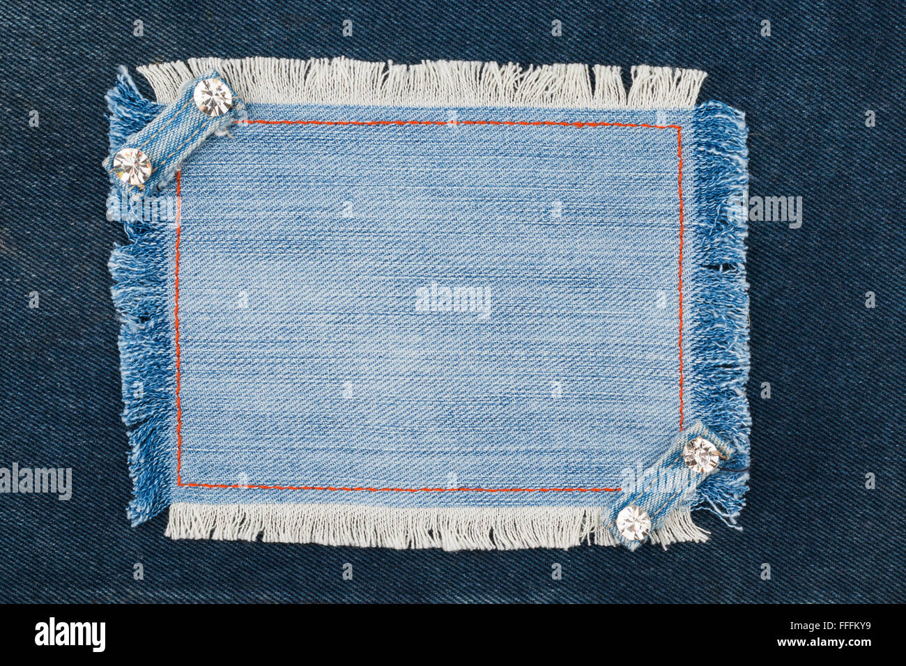 Frame with two straps jeans and rhinestones, lies on the dark denim ...