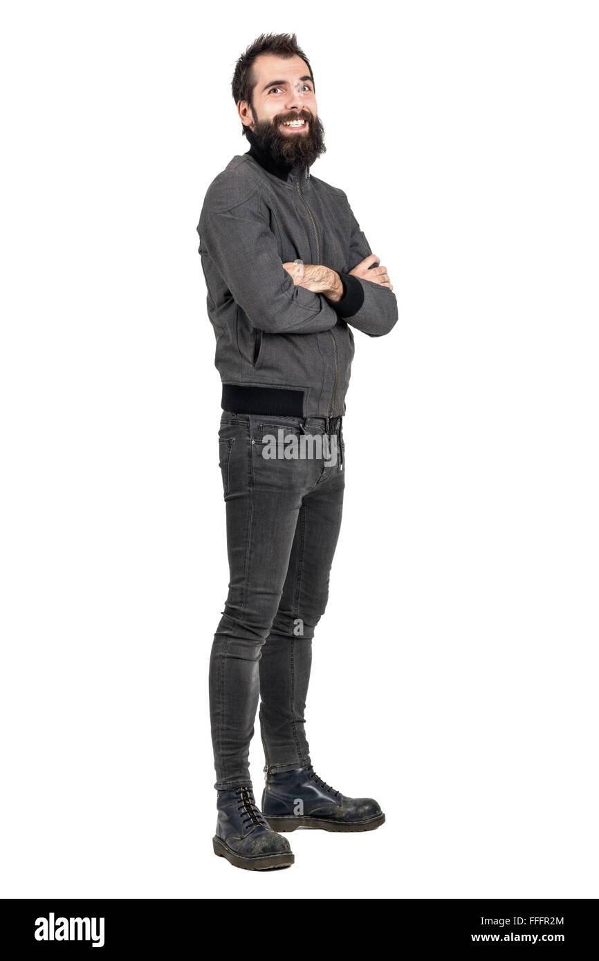 Funny laughing bearded hipster in tight jeans and army boots looking at camera. Full body length portrait isolated over white Stock Photo