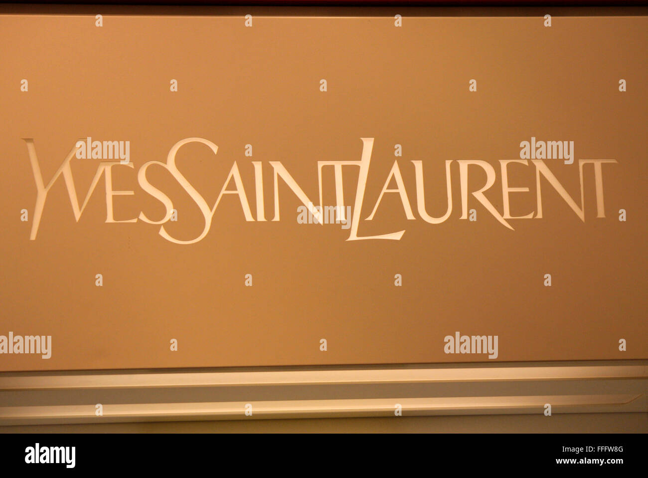 Yves Saint Laurent golden logo, artwork, brown metal background