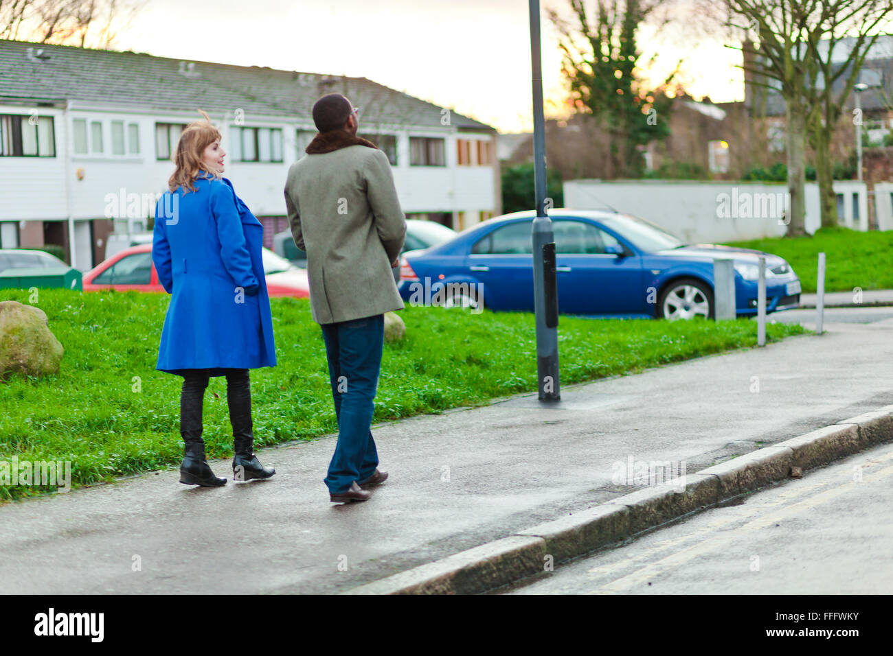 Couple walks and talks at sunset. Stock Photo