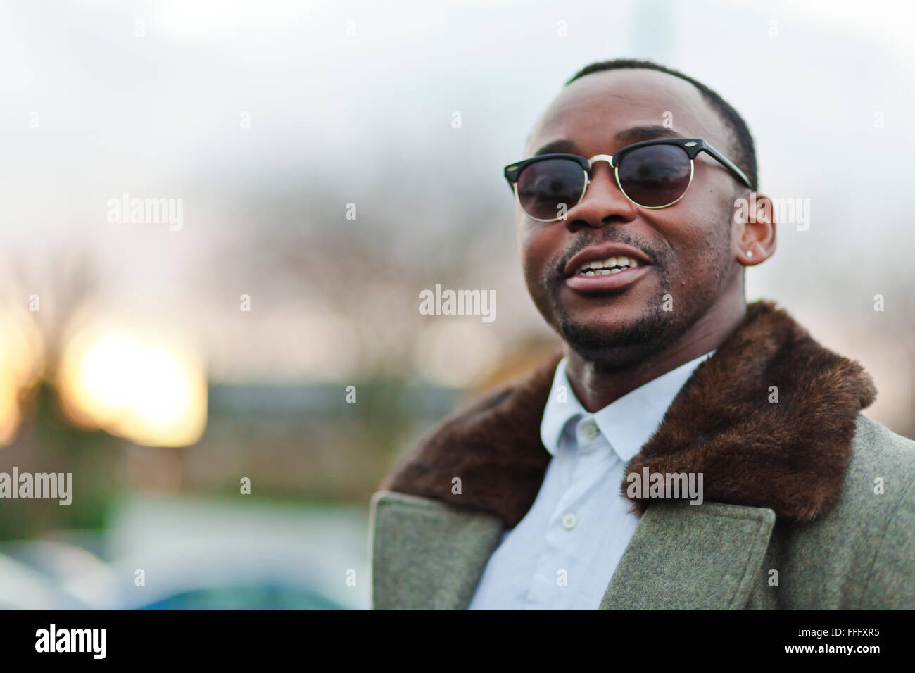 Black man looks away at sunset. Stock Photo