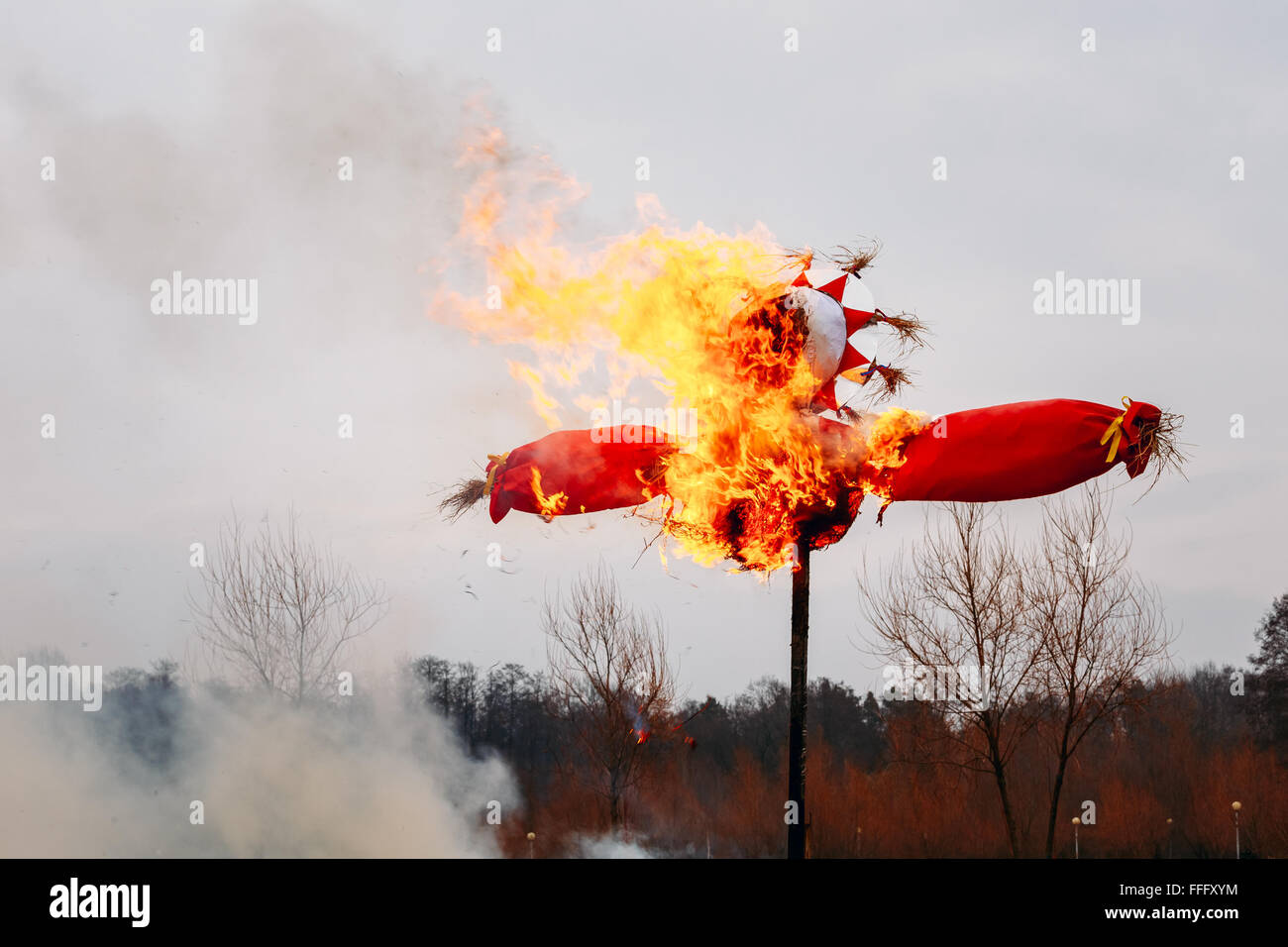 Burning effigies straw Maslenitsa in fire on the traditional holiday dedicated to the approach of spring - Slavic celebration Sh Stock Photo