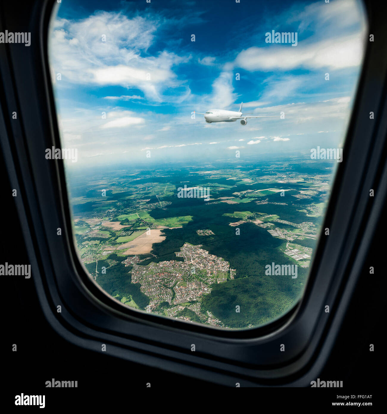 Classic image through aircraft window onto jet engine. The porthole window flies another passenger plane Stock Photo