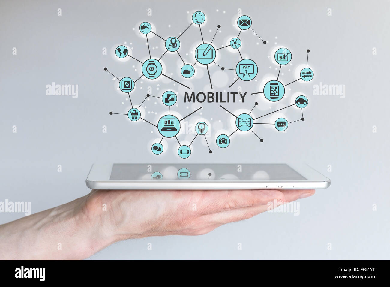Mobility concept. Male hand holding modern smart phone or tablet with illustration of connected mobile devices. Stock Photo