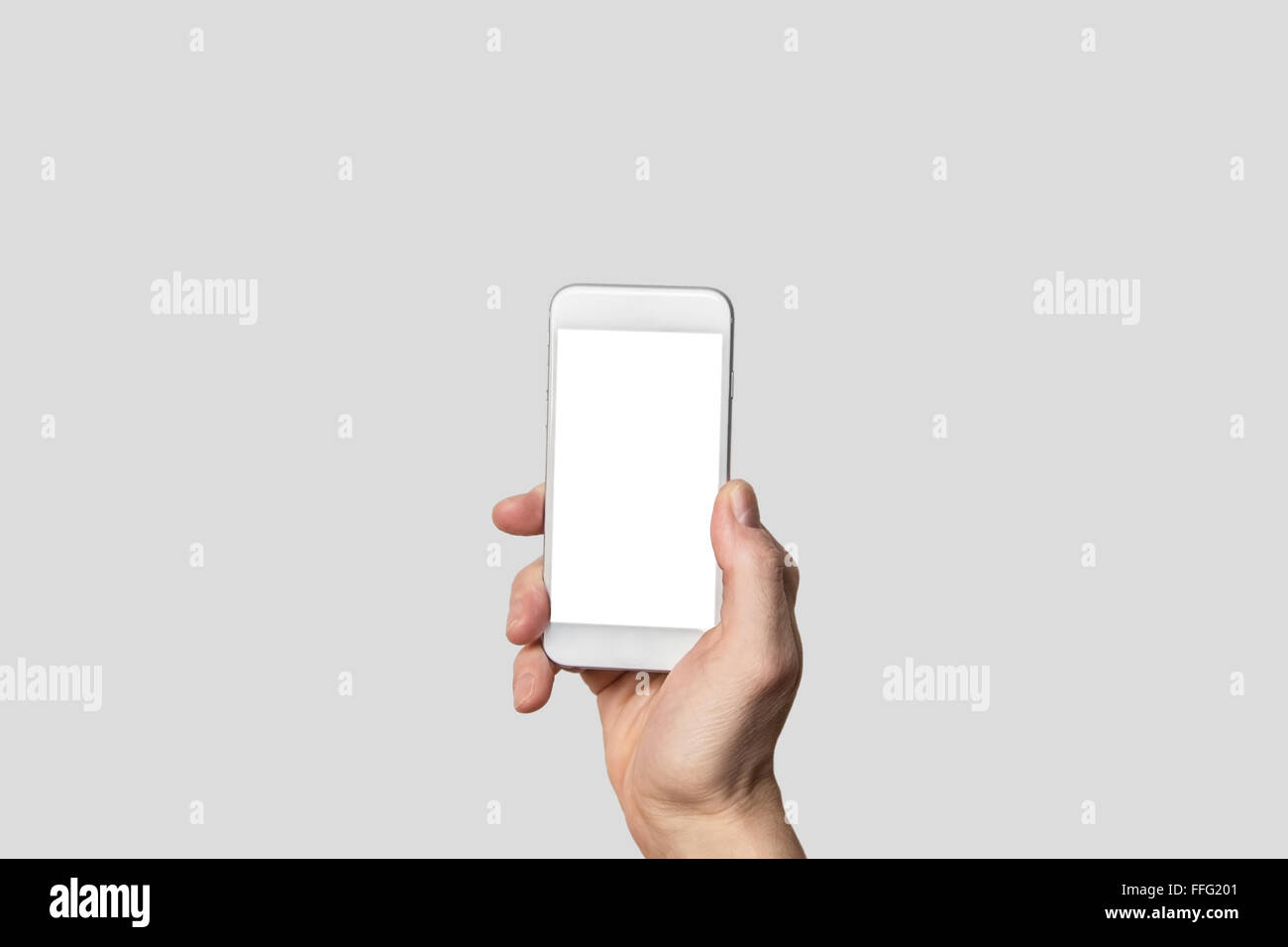 Hand holding modern smartphone in front of isolated background and blank touch screen Stock Photo