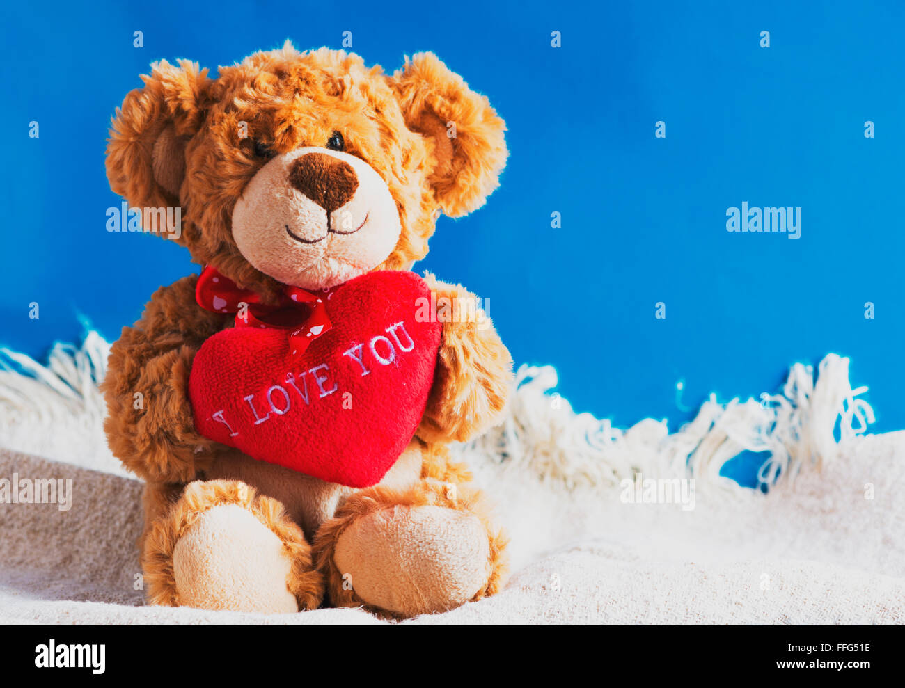 Teddy bear and big red heart with text 'I Love You' Stock Photo