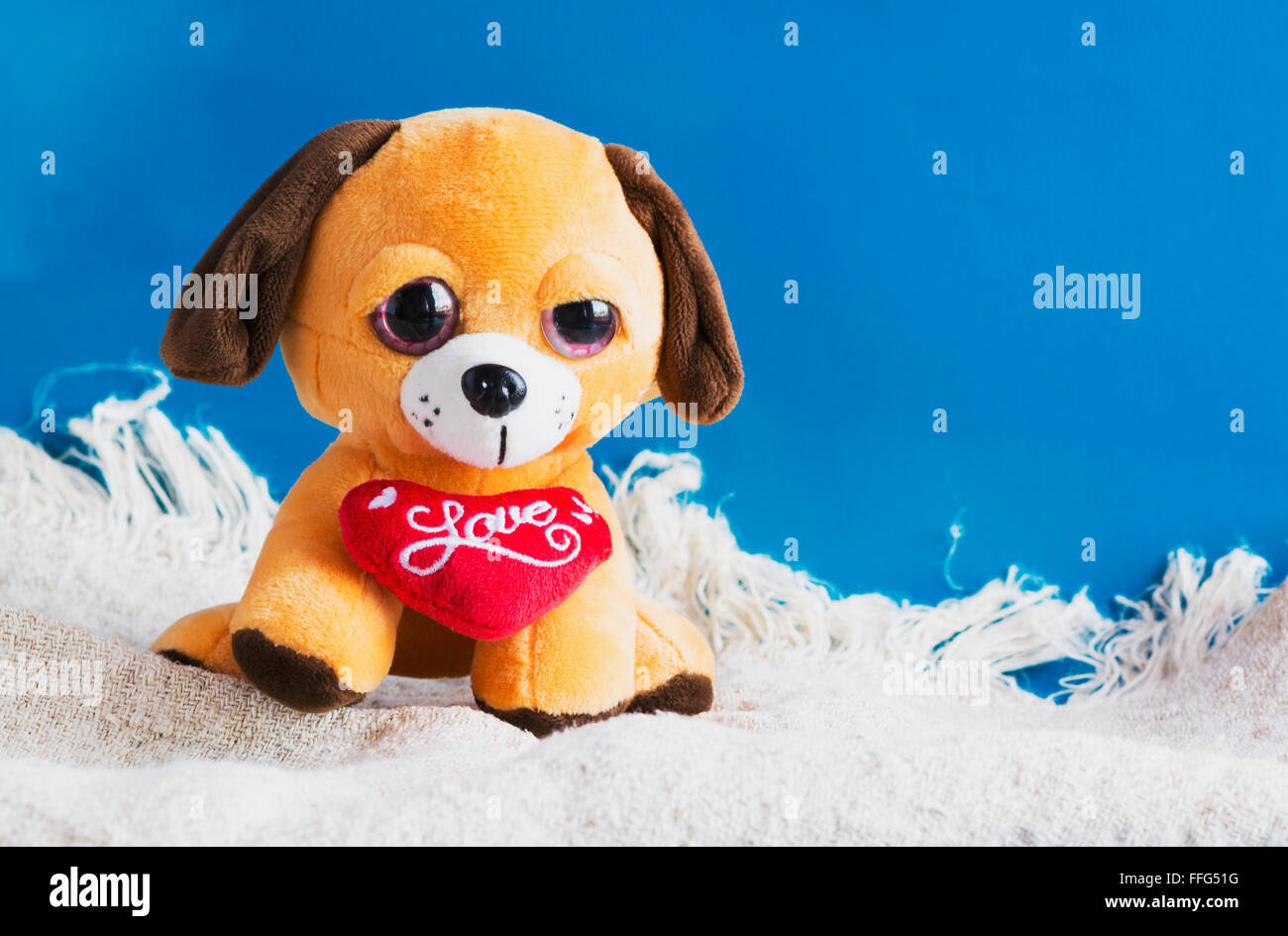 plush toy dog with red heart Stock Photo