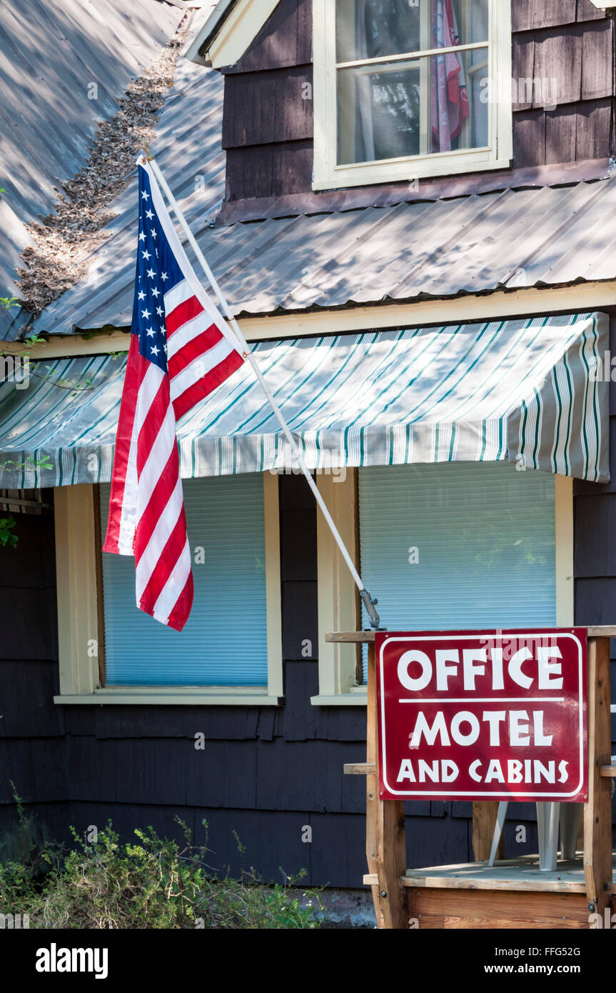 Motel and Cabins Office sign on building flying American flag at a campground in Apgar, Montana. Stock Photo