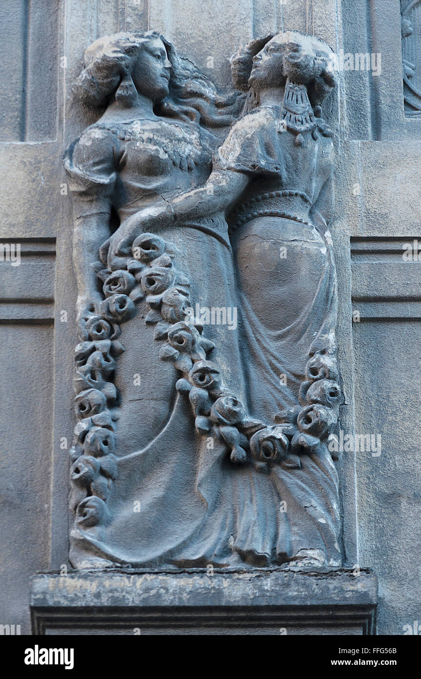 Woman statue on the wall. Architecture detail. Stone sculpture. Parged with plaster Stock Photo