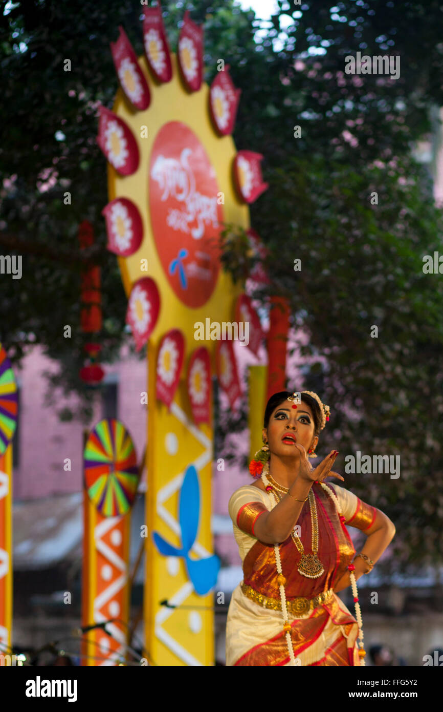 Dhaka, Bangladesh. 13th Feb, 2016. Bangladeshi girl perform a traditional dance during the "Basanta Utsab" or spring Festival in Dhaka in Dhaka, Bangladesh on February 13, 2016. The blazing red and yellow are the representative colours of Pohela Falgun. Pohela Falgun, the first day of spring in the Bengali month of Falgun, is being celebrated today with flowers, poems, songs and dances. It brings joys and colours both in nature and life. After the dryness of winter, new leaves start to come out again and the nature adorns the branches with new colorful flowers such as Shimul, Polash and Marig  Stock Photo