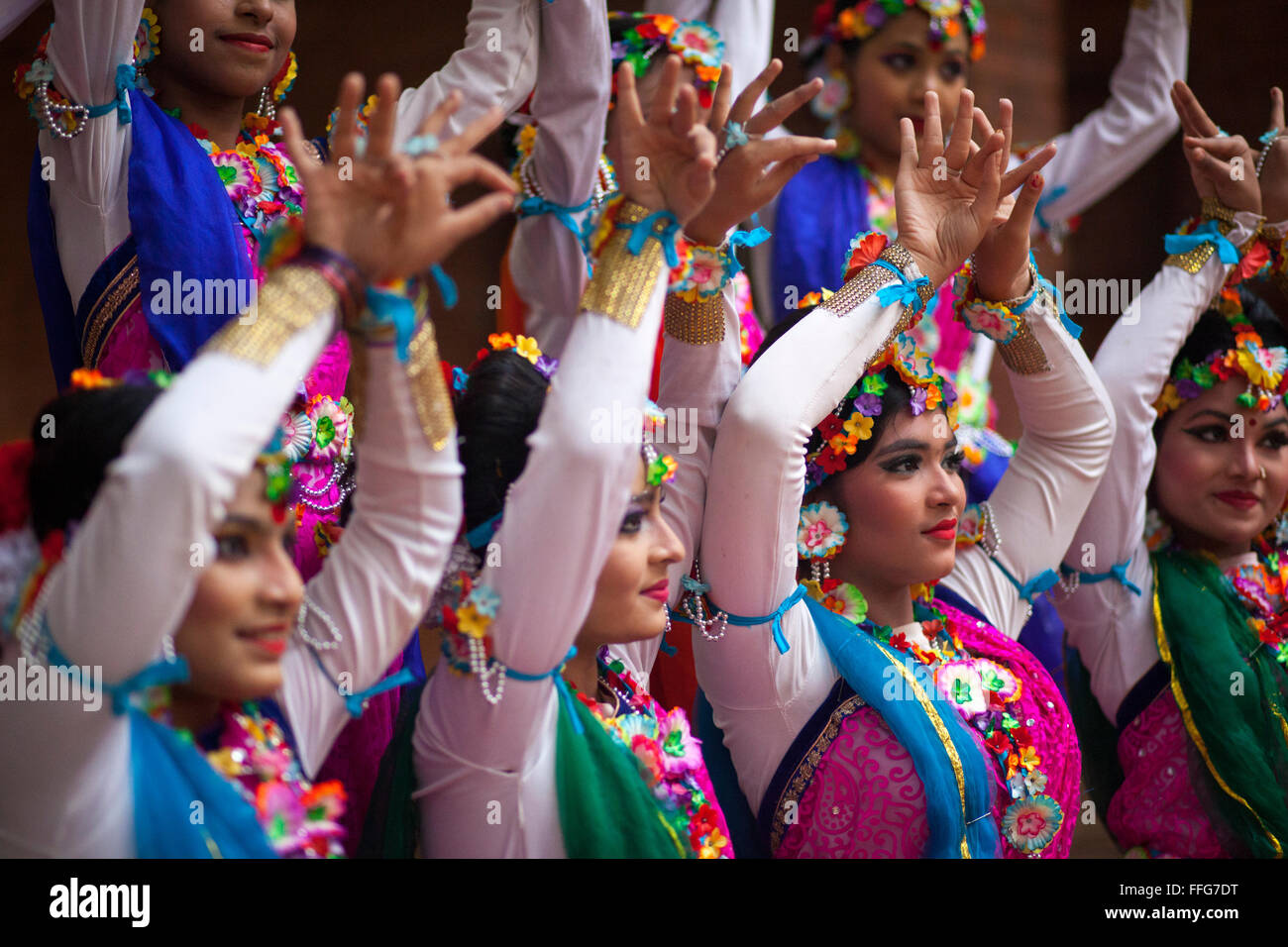 Dhaka, Bangladesh. 13th Feb, 2016. Bangladeshi girl perform a traditional dance during the 'Basanta Utsab' or spring Festival in Dhaka in Dhaka, Bangladesh on February 13, 2016. The blazing red and yellow are the representative colours of Pohela Falgun. Pohela Falgun, the first day of spring in the Bengali month of Falgun, is being celebrated today with flowers, poems, songs and dances. It brings joys and colours both in nature and life. After the dryness of winter, new leaves start to come out again and the nature adorns the branches with new colorful flowers such as Shimul, Polash and Marig  Stock Photo