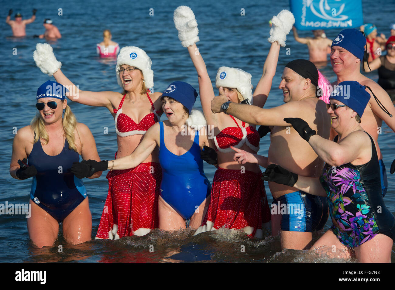 Ahlbeck, Germany. 13th Feb, 2016. Costumed members of winter swimming clubs from Germany and Poland stand in the cold water in the Baltic Sea in Ahlbeck, Germany, 13 February 2016. 195 winter swimmers took part in the 22nd Usedom Winter Swim Spectacle in water temperatures of around 2 degrees. Photo: STEFAN SAUER/dpa/Alamy Live News Stock Photo