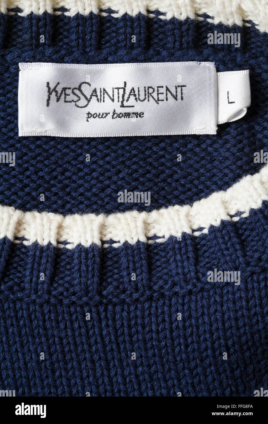 Yves Saint Laurent pour homme label in man's jumper Stock Photo
