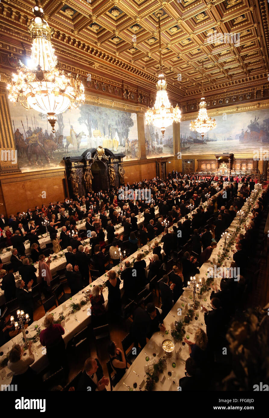 Hamburg, Germany. 12th Feb, 2016. Guests applaud following the speech of Britain's Prime Minister David Cameron at the Matthiae dinner at the city hall of Hamburg, Germany, 12 February 2016. Britain's Prime Minister David Cameron and German Chancellor Angela Merkel are guests of honour at the oldest feast in the world. Since 1356, the leaders of the Hansa city invite distinguished guests to the Matthiae dinner. Photo: CHRISTIAN CHARISIUS/dpa/Alamy Live News Stock Photo