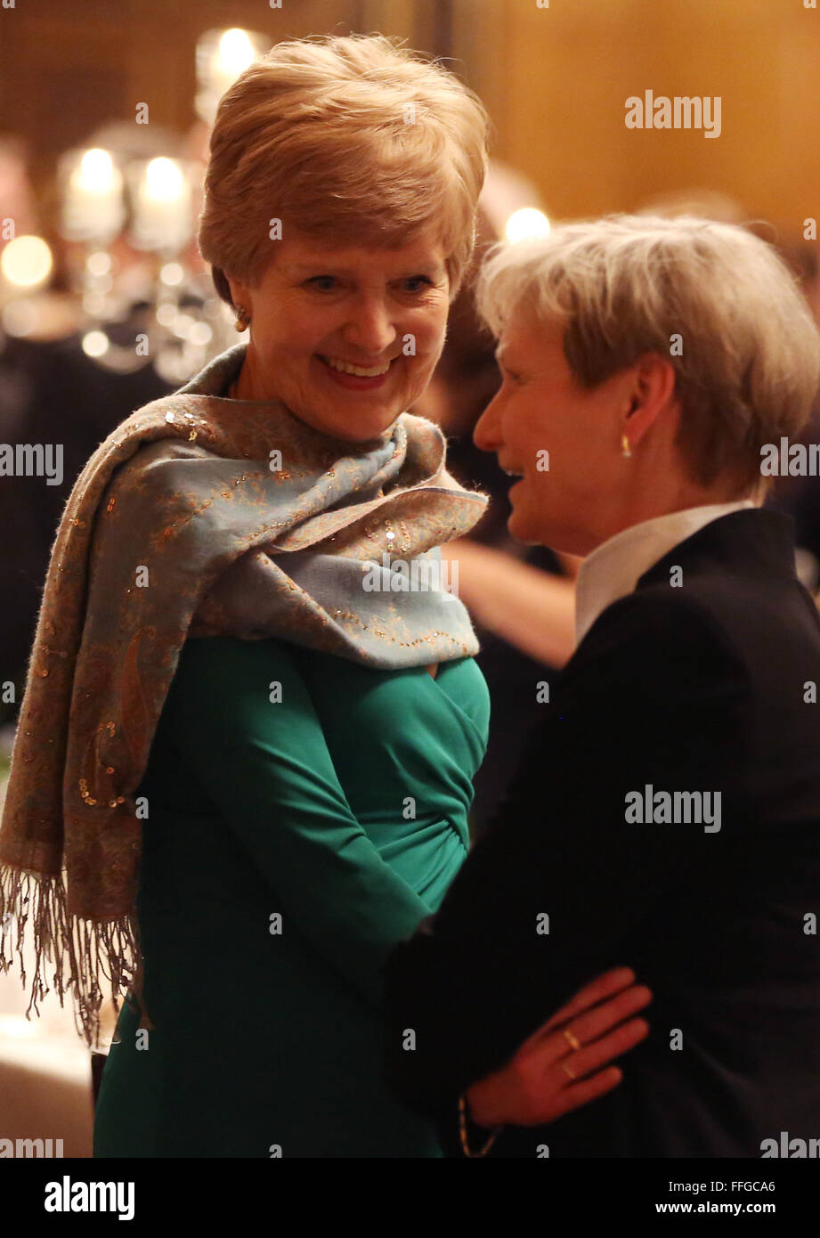 Hamburg, Germany. 12th Feb, 2016. Friede Springer (L), German publisher and widow of Axel Springer, speaks with Bishop of the Evangelical Lutheran Church in Northern Germany, Kirsten Fehrs (R), as she arrives to the Matthiae dinner at the city hall of Hamburg, Germany, 12 February 2016. Britain's Prime Minister David Cameron and German Chancellor Angela Merkel are guests of honour at the oldest feast in the world. Since 1356, the leaders of the Hansa city invite distinguished guests to the Matthiae dinner. Photo: CHRISTIAN CHARISIUS/dpa/Alamy Live News Stock Photo