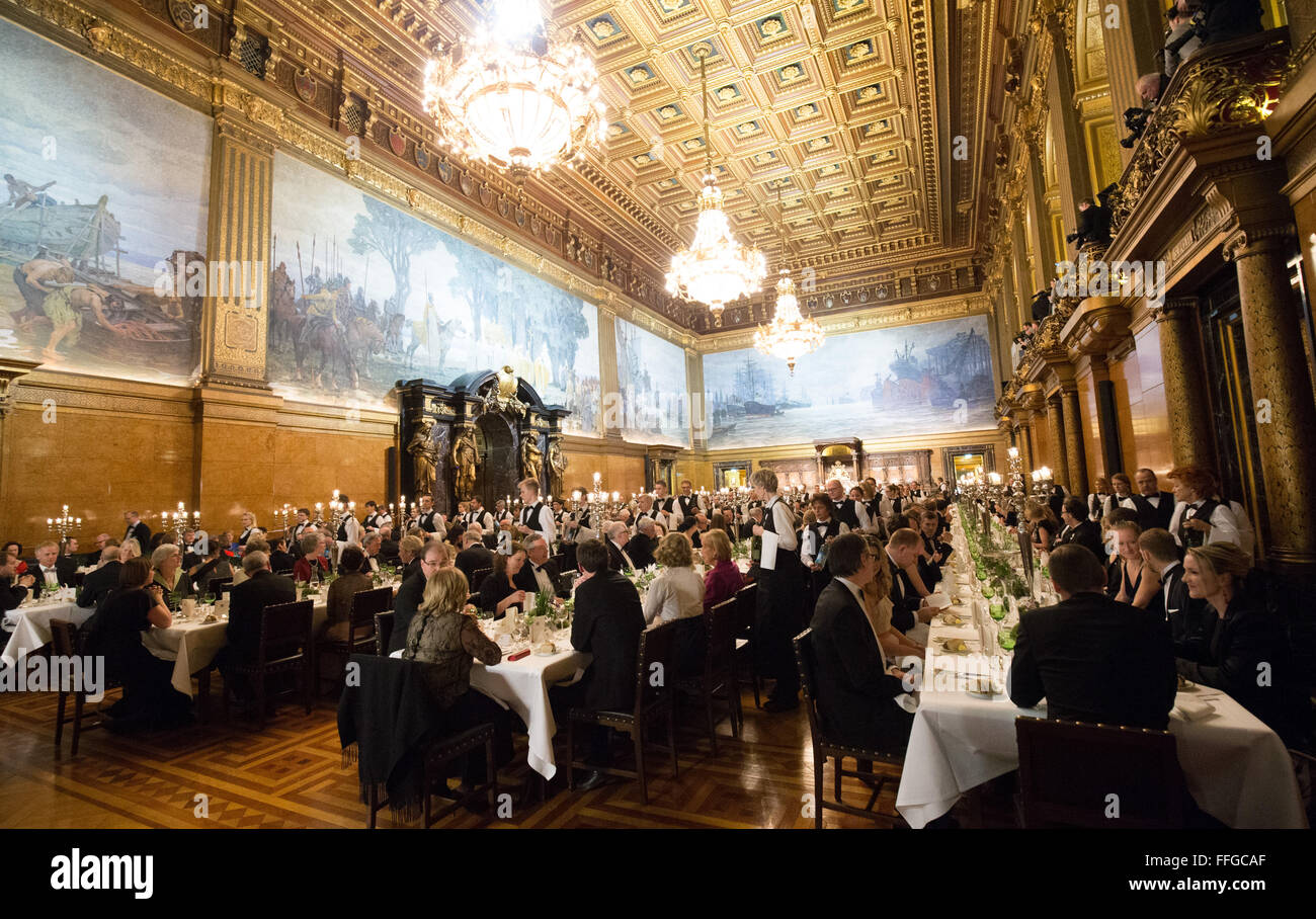 Hamburg, Germany. 12th Feb, 2016. Guests are seated for the Matthiae dinner at the city hall of Hamburg, Germany, 12 February 2016. Britain's Prime Minister David Cameron and German Chancellor Angela Merkel are guests of honour at the oldest feast in the world. Since 1356, the leaders of the Hansa city invite distinguished guests to the Matthiae dinner. Photo: CHRISTIAN CHARISIUS/dpa/Alamy Live News Stock Photo