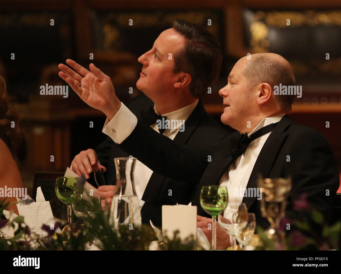 Hamburg, Germany. 12th Feb, 2016. Hamburg's First Mayor Olaf Scholz (R-L) and Britain's Prime Minister David Cameron talk at the annual Matthiae dinner at the city hall of Hamburg, Germany, 12 February 2016. Britain's Prime Minister David Cameron and German Chancellor Angela Merkel are guests of honour at the oldest feast in the world. Since 1356, the leaders of the Hansa city invite distinguished guests to the Matthiae dinner. Photo: CHRISTIAN CHARISIUS/dpa/Alamy Live News Stock Photo