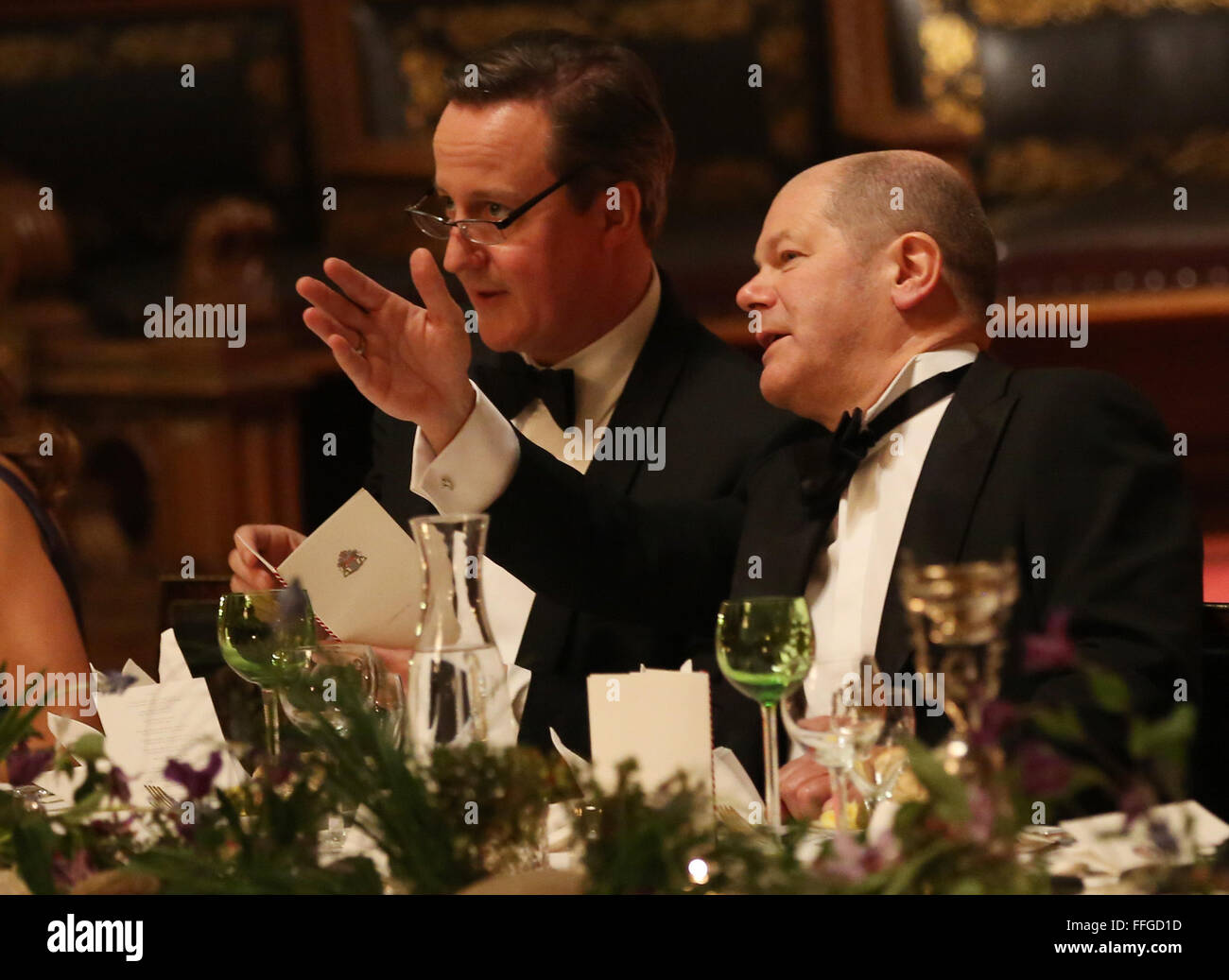 Hamburg, Germany. 12th Feb, 2016. Hamburg's First Mayor Olaf Scholz (R-L) and Britain's Prime Minister David Cameron talk at the annual Matthiae dinner at the city hall of Hamburg, Germany, 12 February 2016. Britain's Prime Minister David Cameron and German Chancellor Angela Merkel are guests of honour at the oldest feast in the world. Since 1356, the leaders of the Hansa city invite distinguished guests to the Matthiae dinner. Photo: CHRISTIAN CHARISIUS/dpa/Alamy Live News Stock Photo