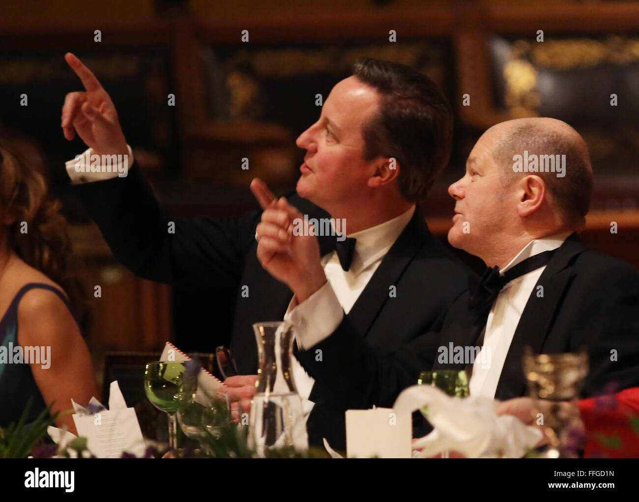 Hamburg, Germany. 12th Feb, 2016. Hamburg's First Mayor Olaf Scholz (R-L) and Britain's Prime Minister David Cameron talk at the annual Matthiae dinner at the city hall of Hamburg, Germany, 12 February 2016. Britain's Prime Minister David Cameron and German Chancellor Angela Merkel are guests of honour at the oldest feast in the world. Since 1356, the leaders of the Hansa city invite distinguished guests to the Matthiae dinner. Photo: CHRISTIAN CHARISIUS/dpa/Alamy Live News Stock Photo