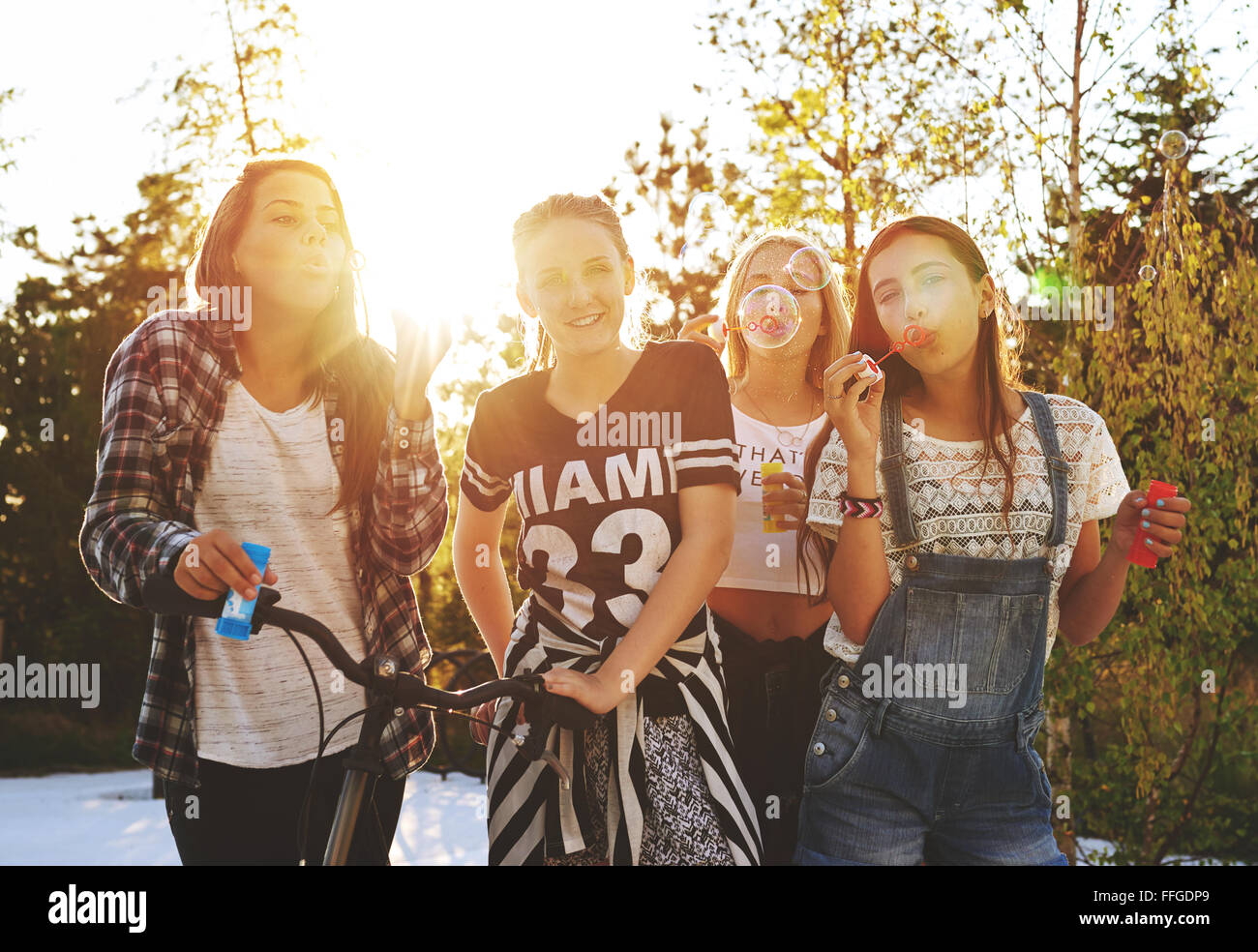 Teenagers having fun while posing for the camera outside Stock Photo